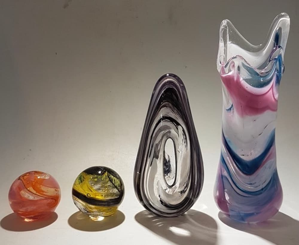 a selection of coloured glass objects made on a glassblowing experience