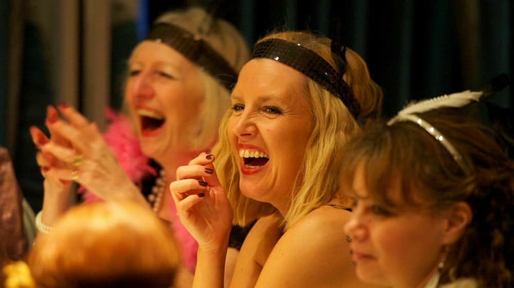 guests laughing and having fun on a murder mystery weekend experience