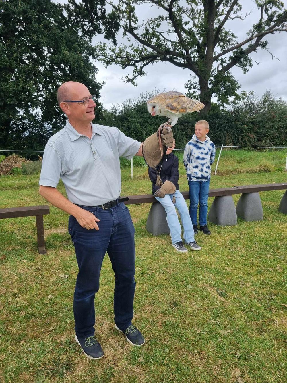 Man holding a barn owl