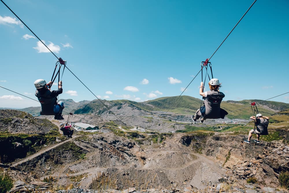 people going down zip lines over a quarry on a zip world titan experience day