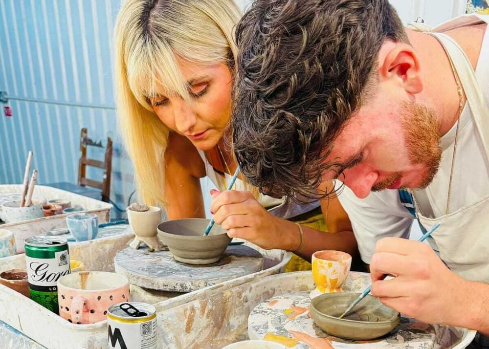two people painting pottery on a pottery painting experience in london