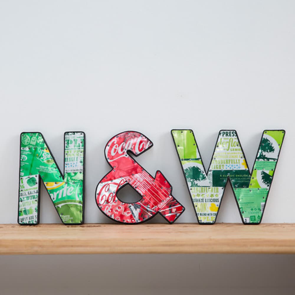 metal letters displayed on shelf made from recycled drinks cans