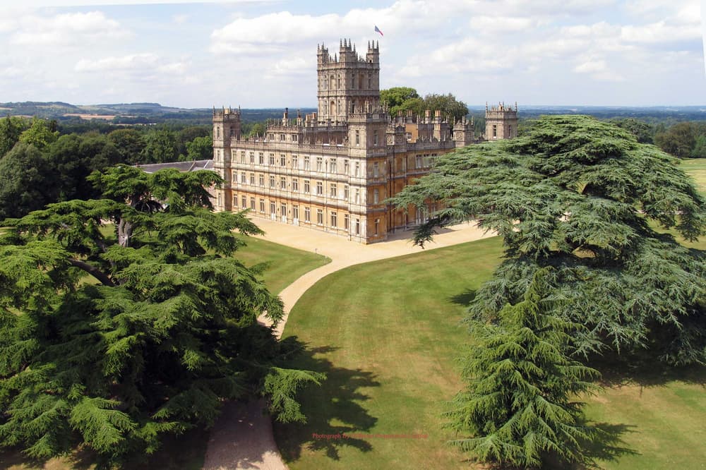the view of highclere castle which was used as the setting for downtown abbey seen on a guided coach tour of downtown abbey
