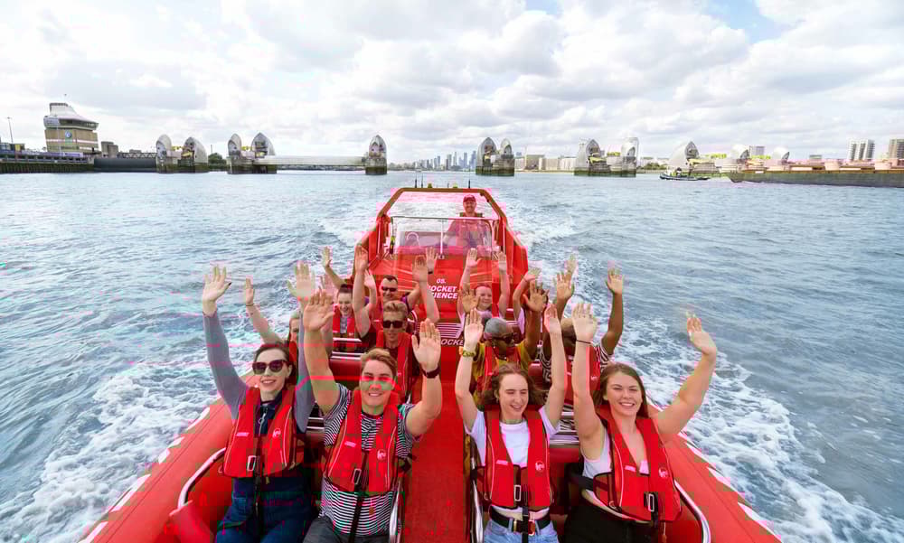 happy passengers on a thames rockets speedboat for a break the barrier experience on the thames in london