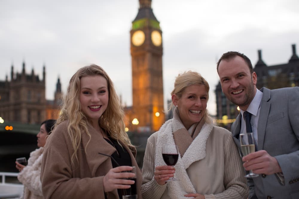 Family on river cruise in front of big ben