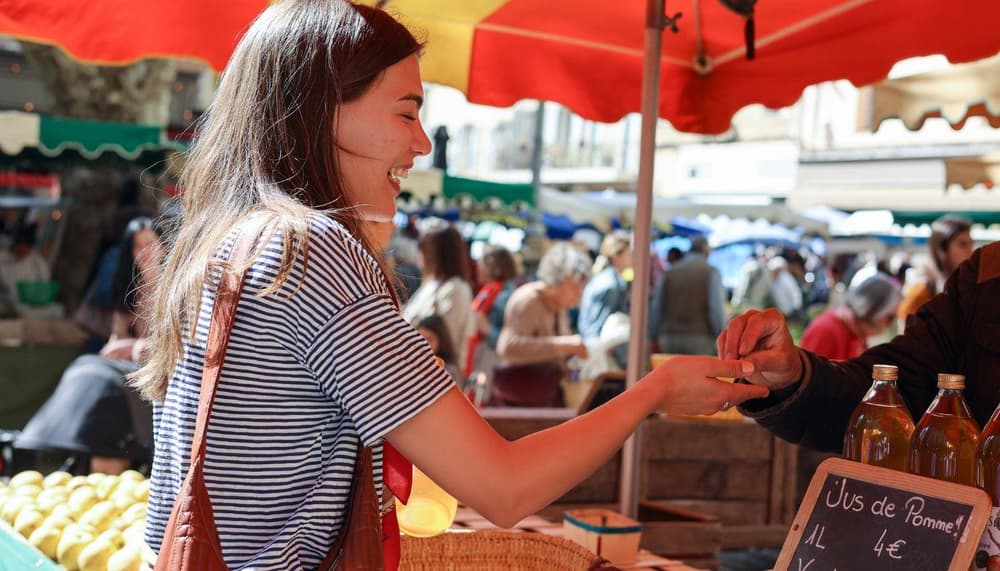 Lady buying something from a farmers market