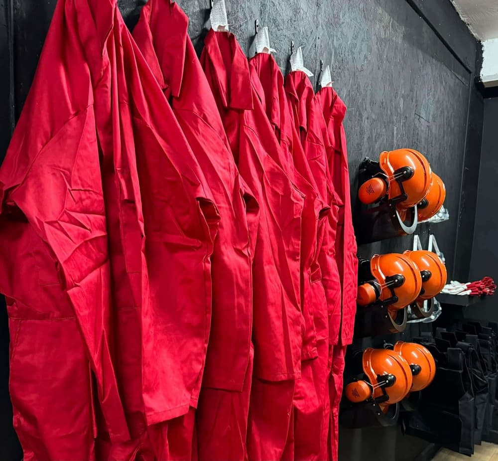Overalls and helmets on wall for rage room experience min