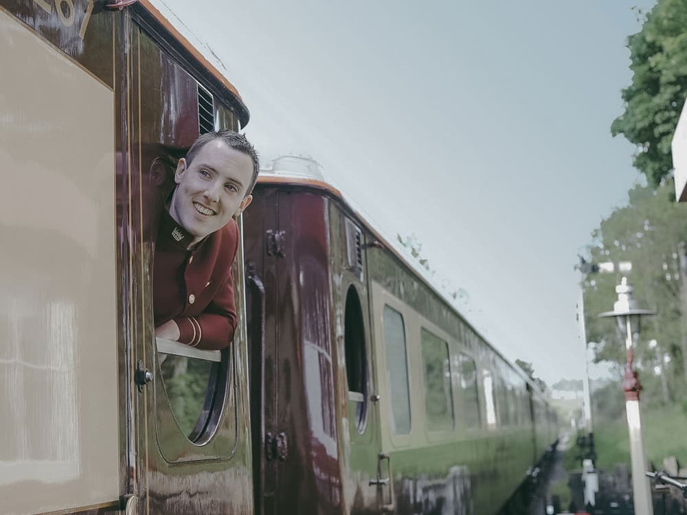 Train steward looking out of carriage window