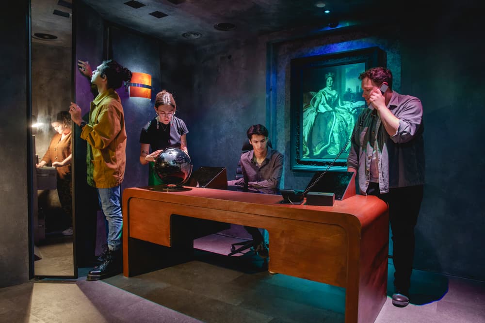 five people looking for clues on a sherlock holmes escape room experience