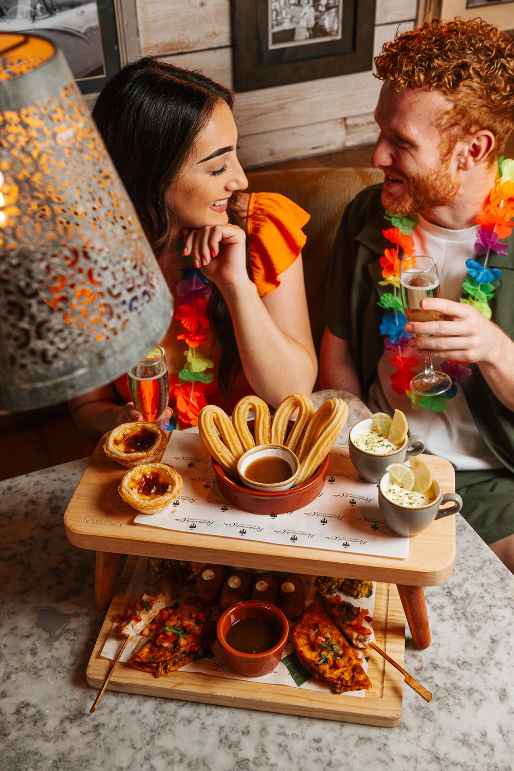 a man and a woman at a cuban inspired afternoon tea experience at revolucion de cuba