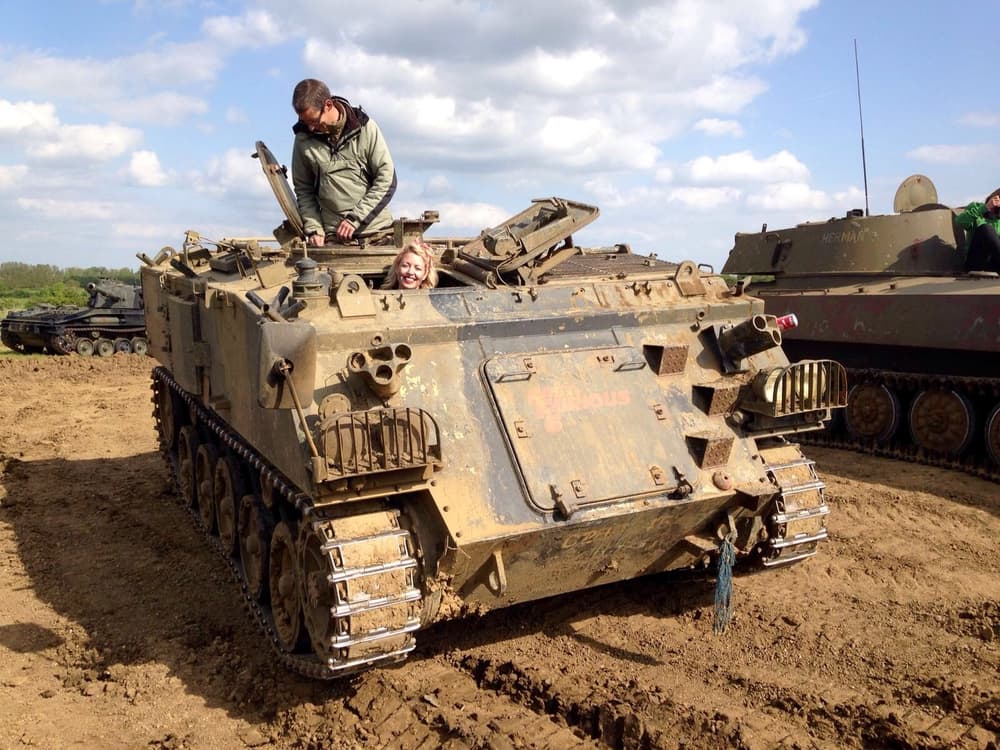 woman driving a military tank on a tank driving experience day