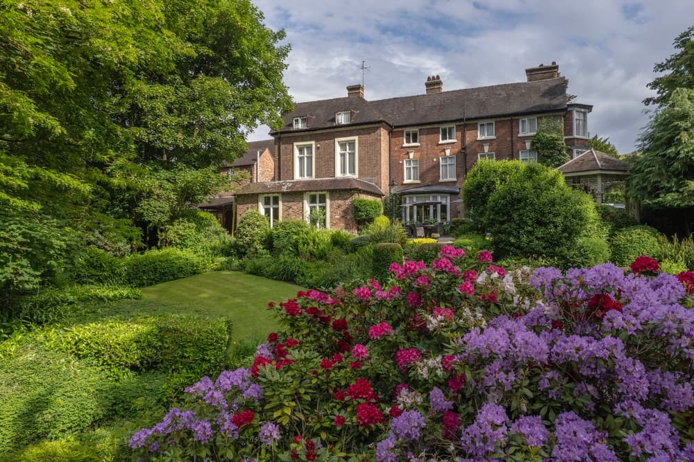 a view of a country hotel with its gardens in bloom in ironbridge in shropshire