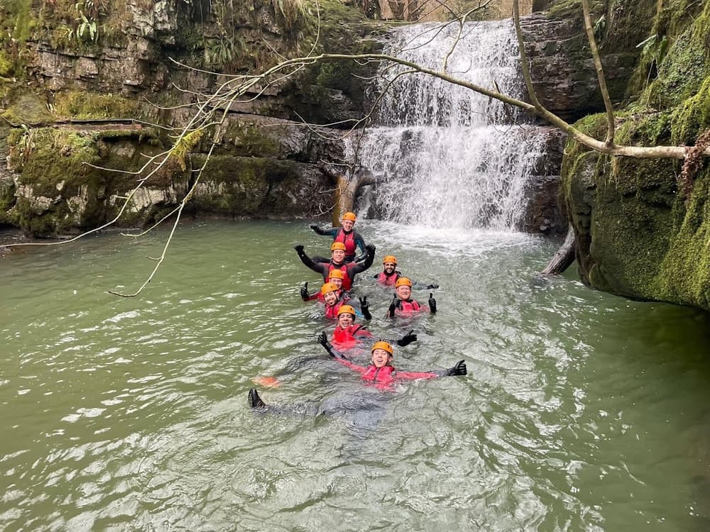 Canyoning experience in waterfall lake