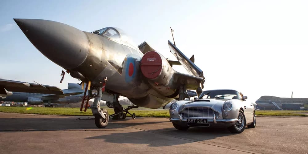 a vintage car next to a vintage fighter aircraft on a runway