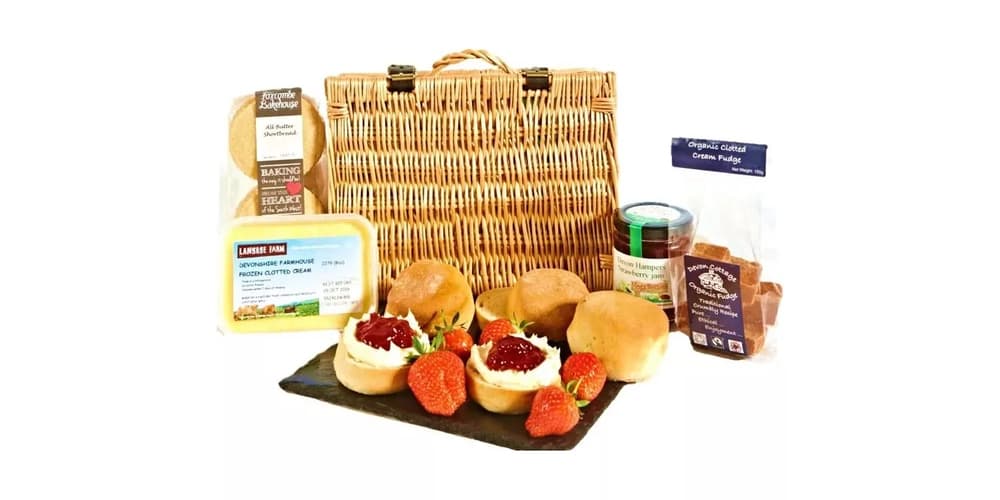 a devon hamper with scones, jam and cream in a wicker hamper