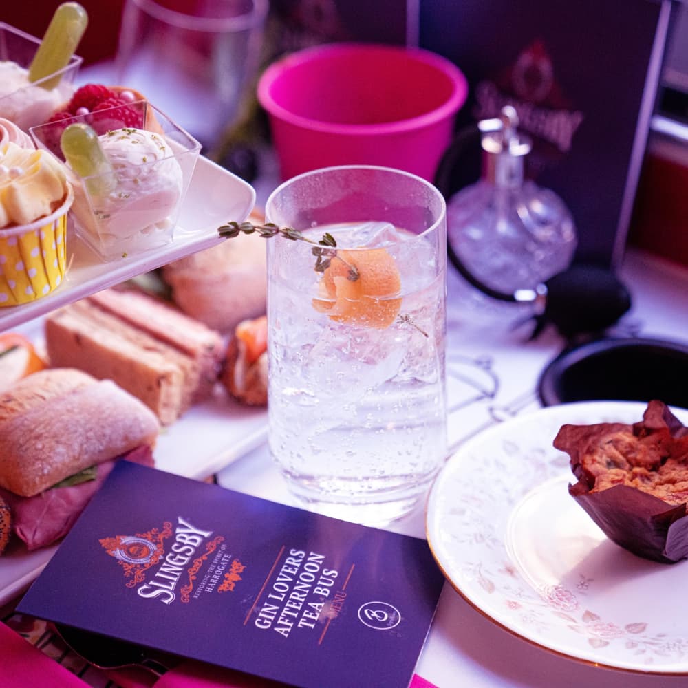 close up of the food and drink laid out for the gin lovers afternoon tea bus tour