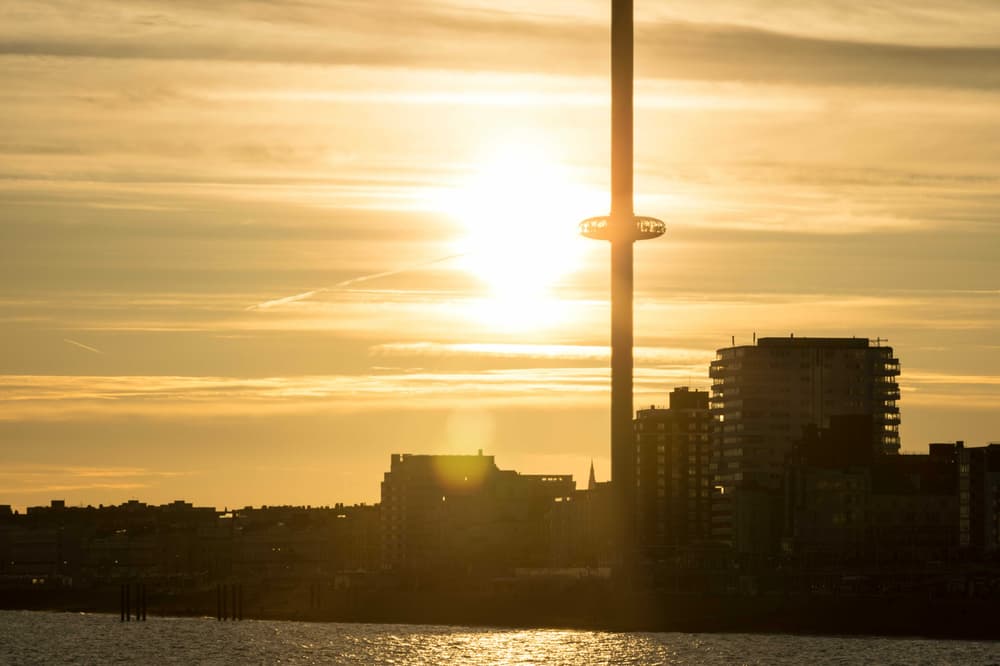 a view of the i360 in brighton with the sun behind it