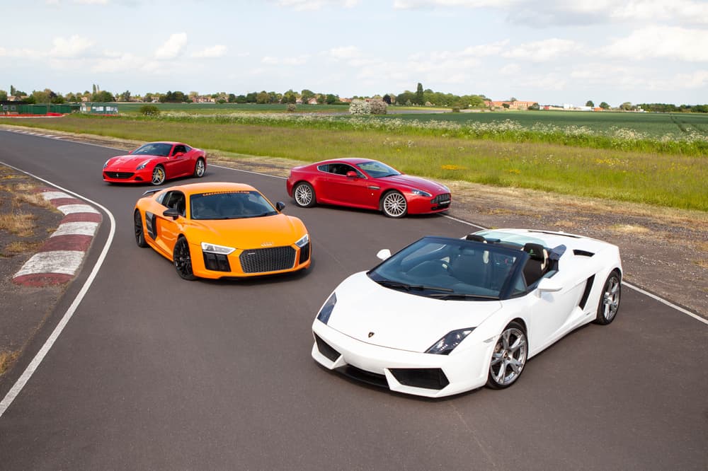 four supercars on a race track for a driving day experience