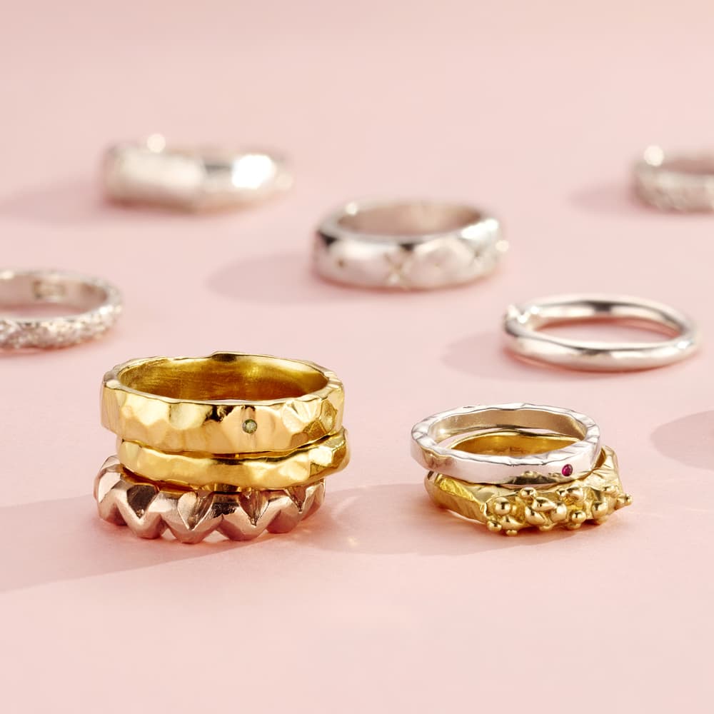 a selection of silver and gold rings shown as examples of what you can make on a ring making experience