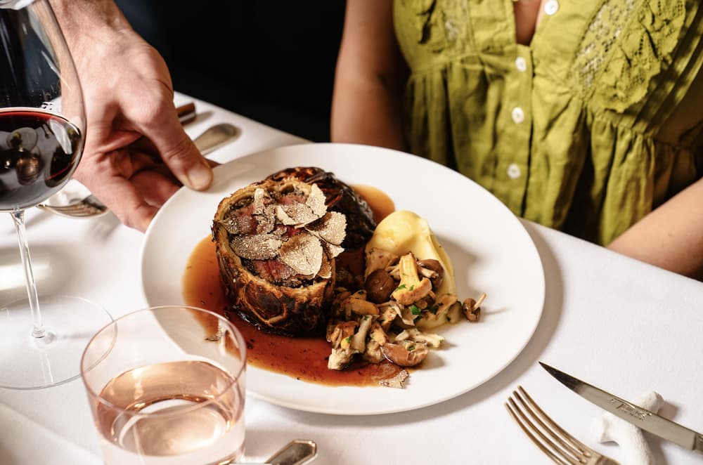 A beef wellington meal being served at corrigans mayfair