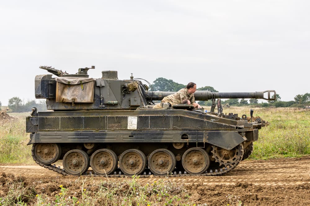 the abbott spg tank being driven across a muddy field on a tank driving experience day