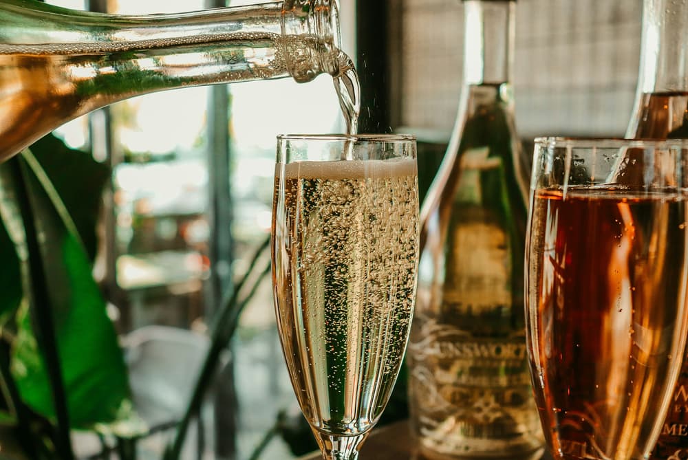 sparkling wine being poured into a glass