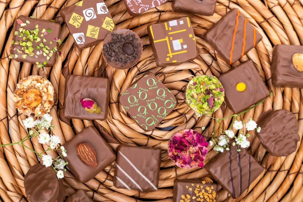 wicker board full of decorated chocolate squares