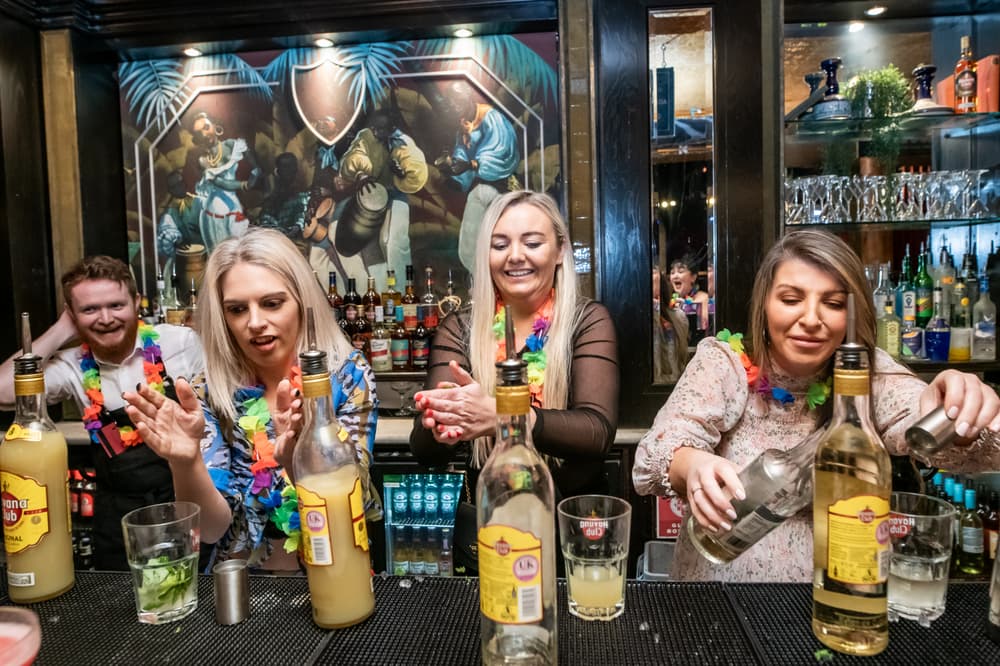 three ladies mixing cocktails on a cocktail masterclass at revolucion de cuba