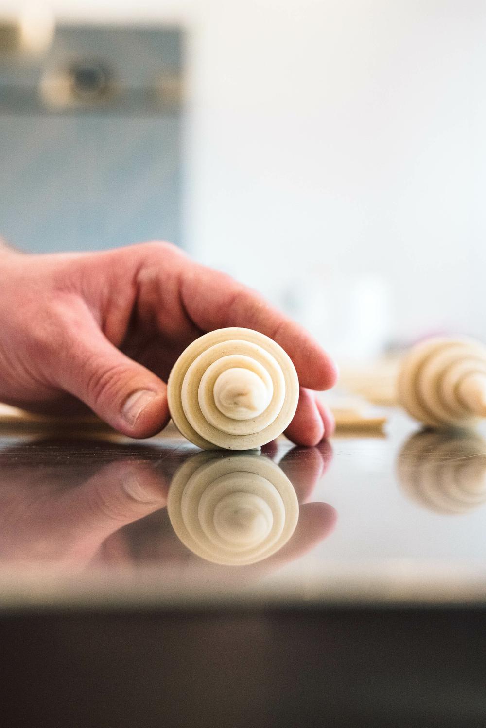croissant dough being rolled on a croissant making masterclass
