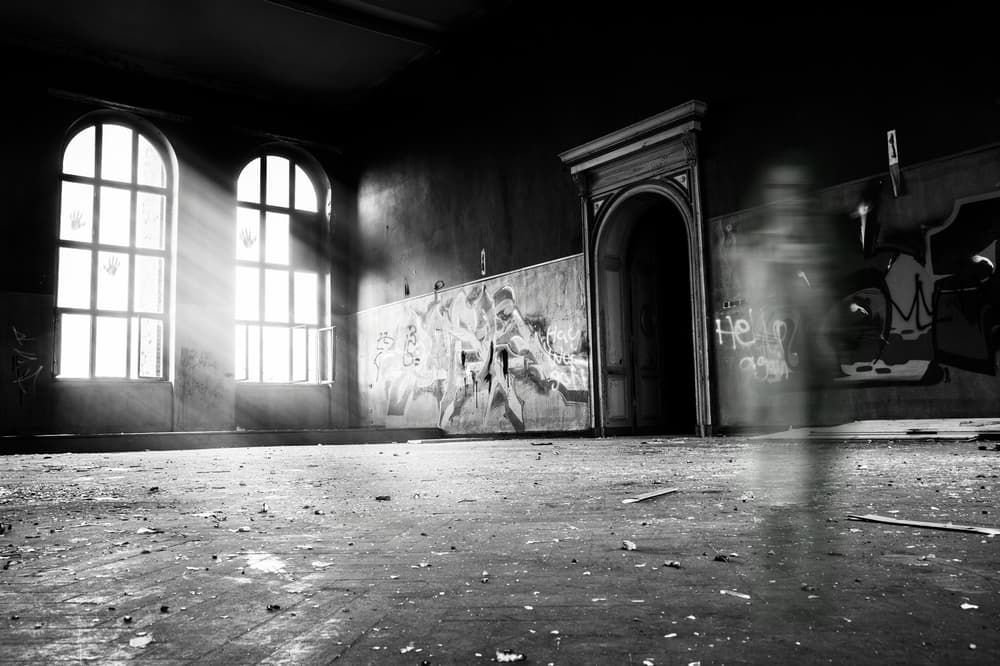 black and white photo of a run down empty building