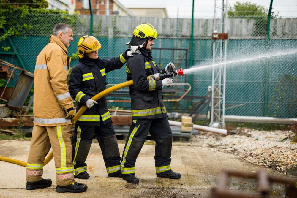 Holding a water hose firefighter experience min