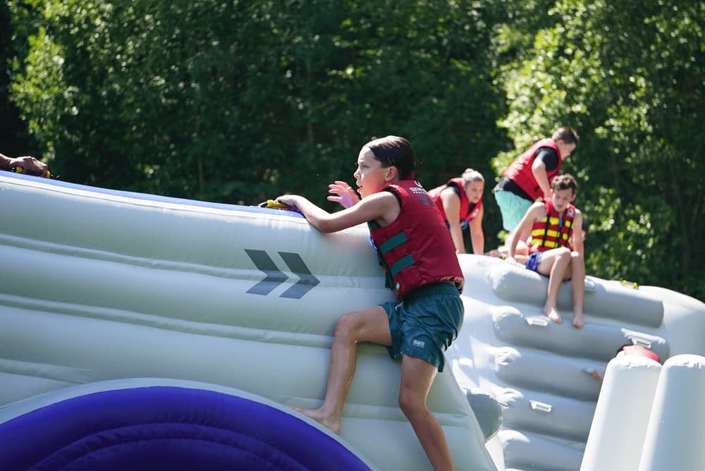 Kids playing on inflatable water park