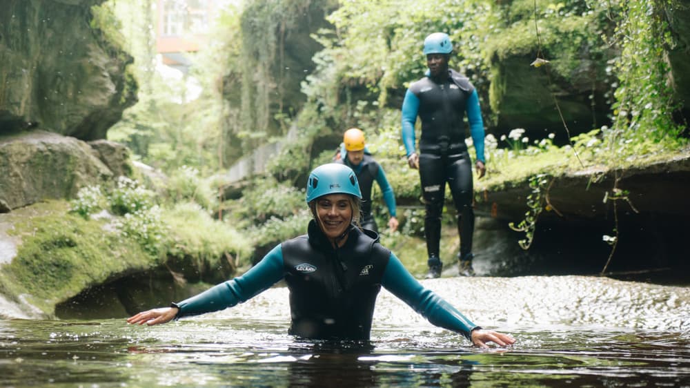Lady smiling in water while gorge walking