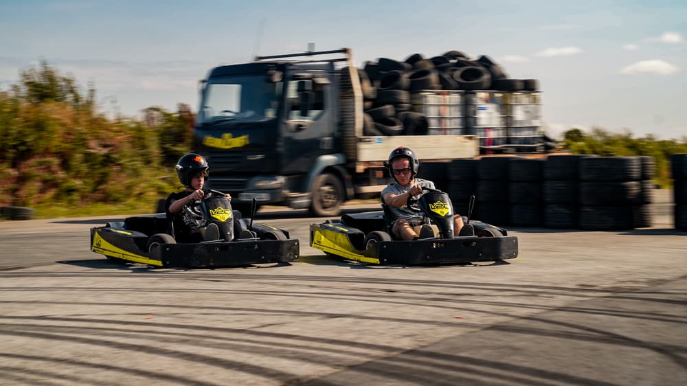 man and boy on drift karting experience going around track