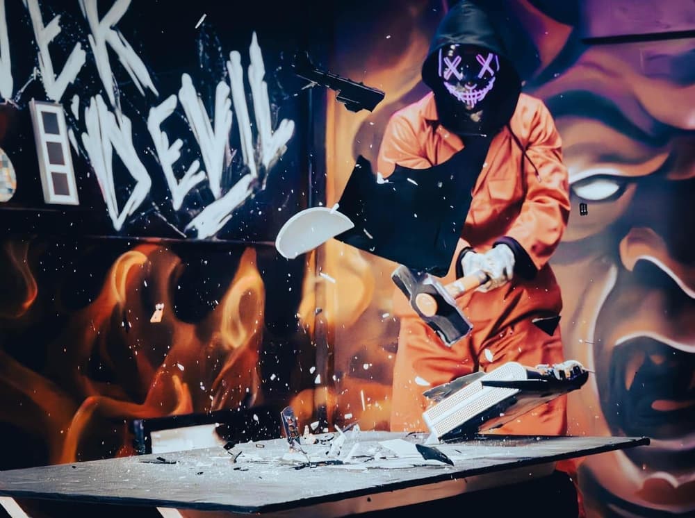 Person smashing tv on a rage room experience min
