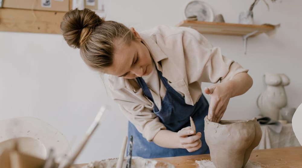 women making something out of clay on a pottery experience day
