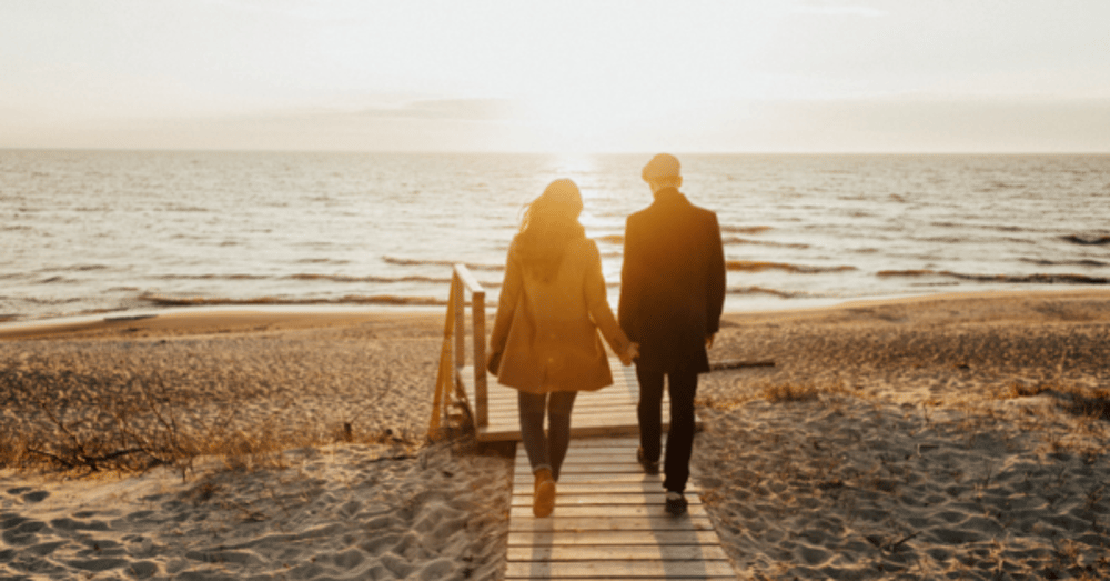 couple walking on the beach as part of a romantic hotel break