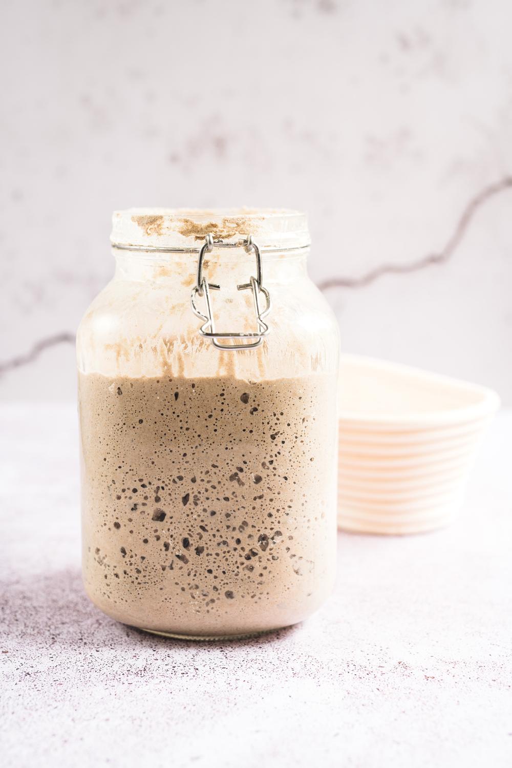 a sourdough start in a glass jar used on a sourdough bread making masterclass