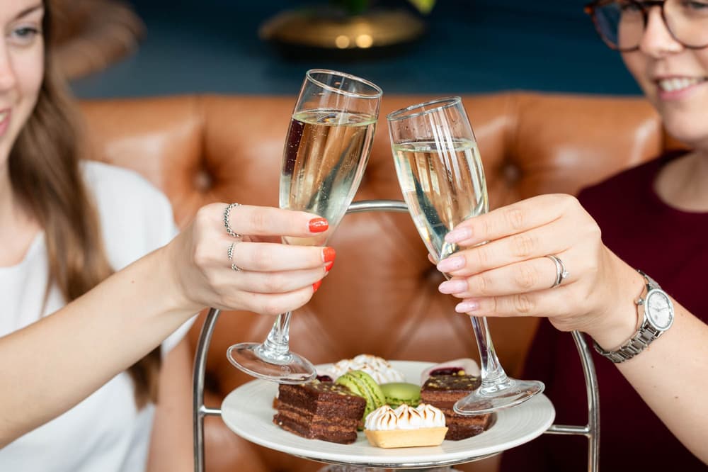 Women enjoying a champagne afternoon tea at doubletreeby hilton brighton metropole