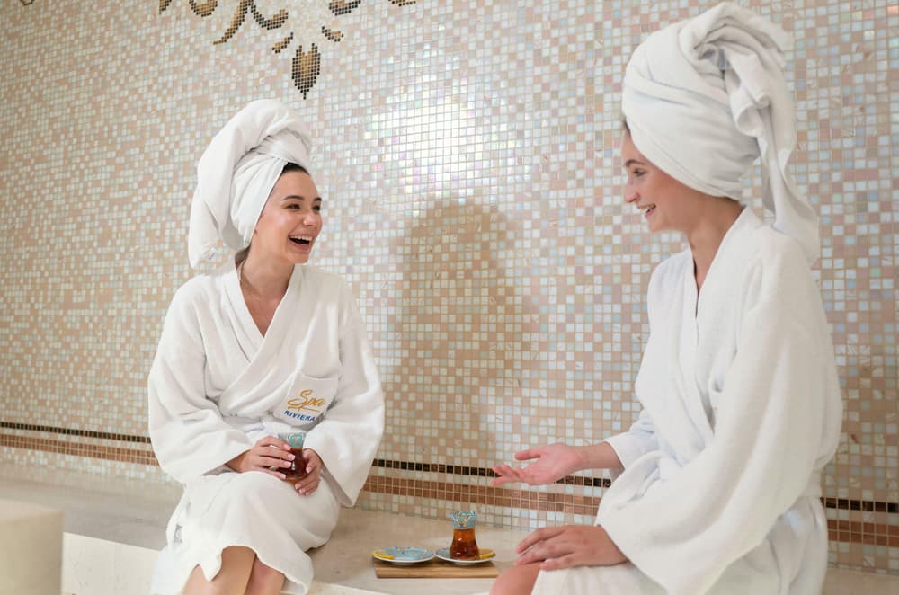 Women wearing sunglasses and head towels