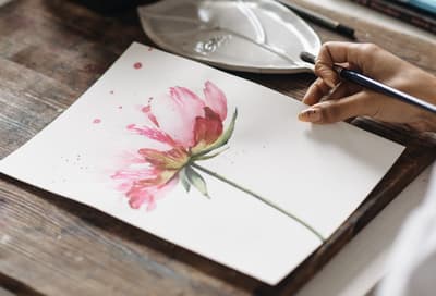 a pink watercolour flower on a piece of white paper done on a watercolour introduction experience