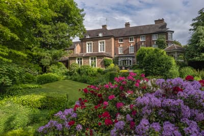 a view of a country hotel with its gardens in bloom in ironbridge in shropshire