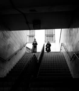 black and white photo of two people stood at the top of steps taken on a photography workshop with benson spiers