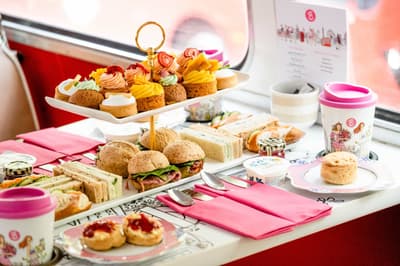 afternoon tea spread of cakes and sandwiches on an afternoon tea bus tour in london