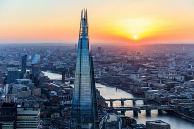 a view of the top of the shard at sunset against the london skyline