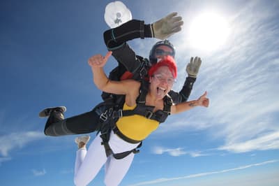 a woman on a tandem skydiving experience during freefall