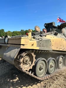 a man driving a tank on tank driving experience