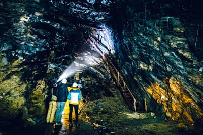 People exploring the underground slate mine at zip world llechwedd in wales