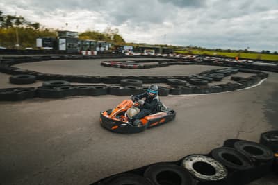 person racing in a go-kart around a track at midland karting