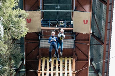two people doing the plummet free fall experience at zip world